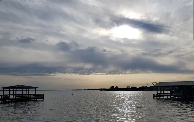 a view of a lake with city in the background