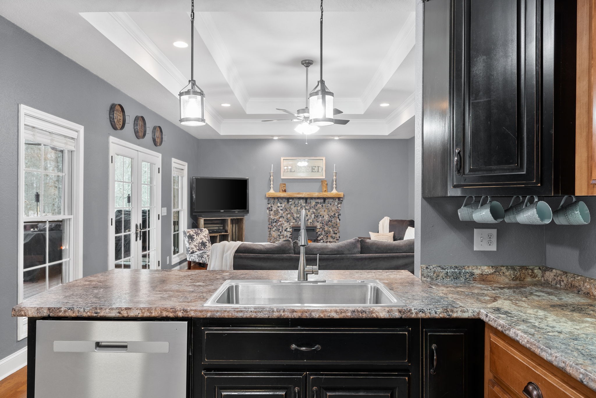 a kitchen with granite countertop stainless steel appliances a sink and a counter top