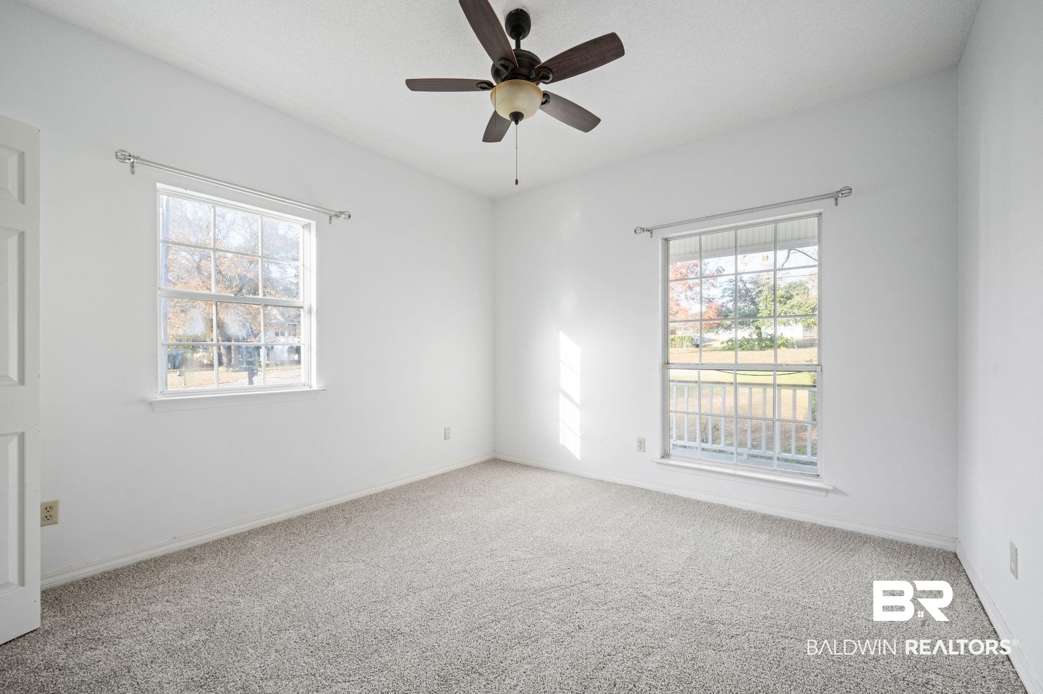 100 Orleans Way Daphne, AL 36526 - Photo 22 of 31 Empty room featuring ceiling fan, carpet floors, and a healthy amount of sunlight