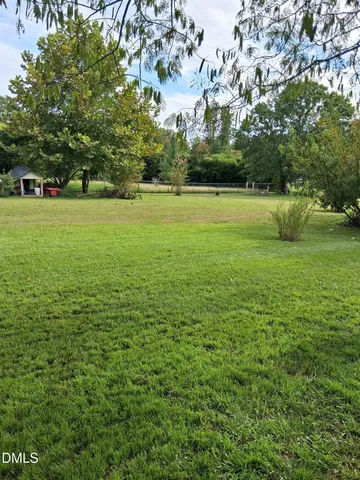 a view of swimming pool with a yard