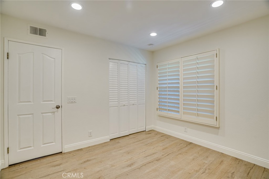 49 East Yale Loop, Unit 26 Irvine, CA 92604 - Photo 29 of 63 a view of an empty room with wooden floor