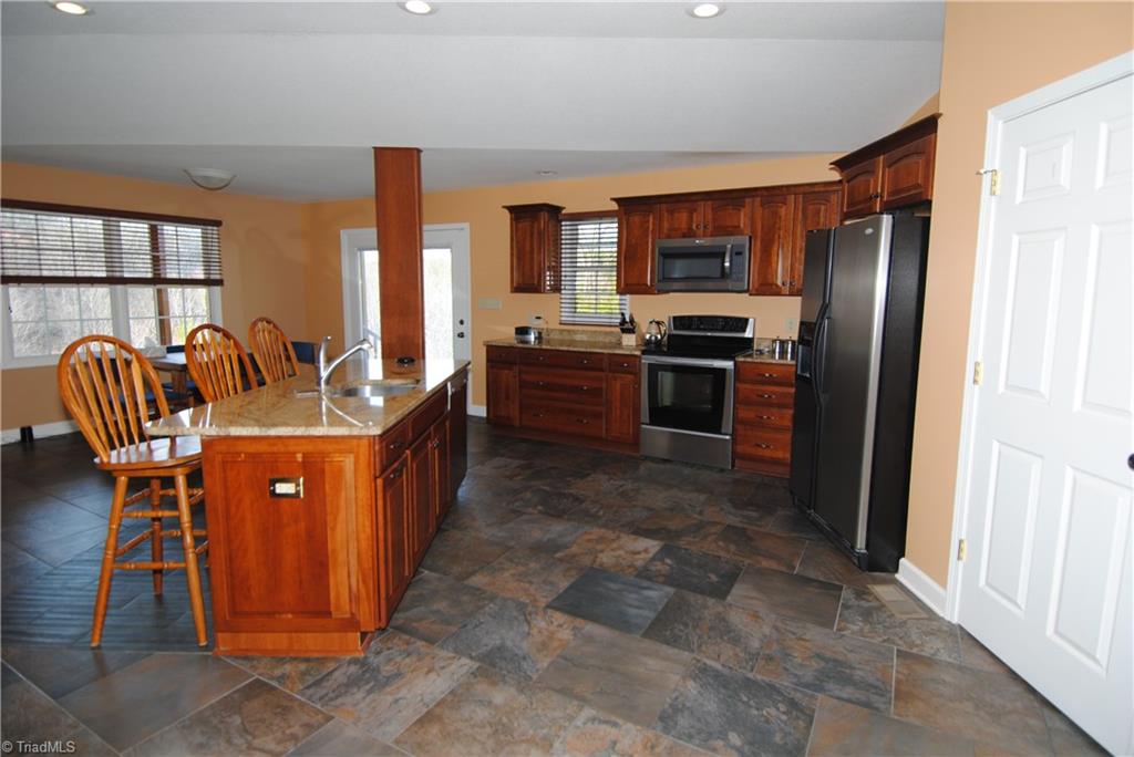 2273 Volunteer Road Pinnacle, NC 27043 - Photo 10 of 30 Spacious kitchen w/stainless steel & granite counters.
