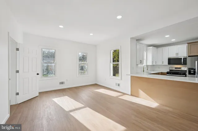 a view of kitchen with wooden floor and window