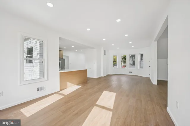 a view of kitchen and hall with wooden floor and windows