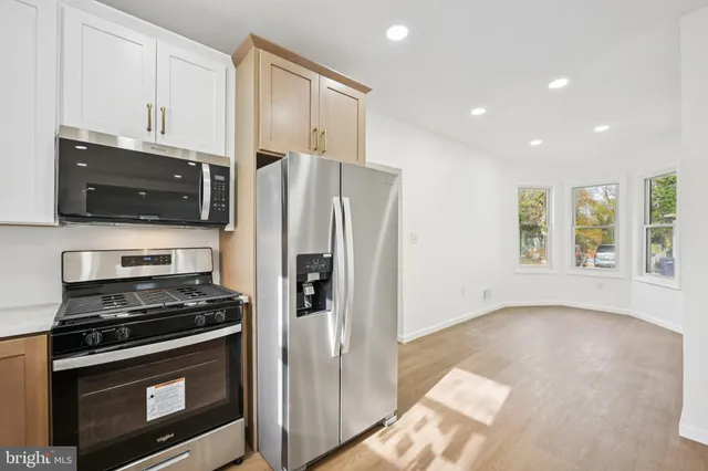 a kitchen with stainless steel appliances a stove microwave and refrigerator