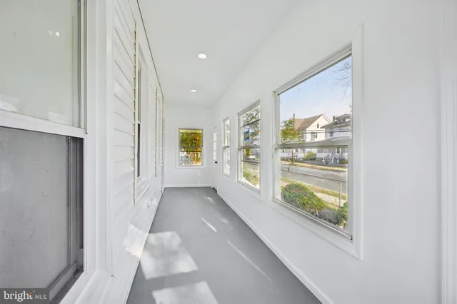 a view of hallway with furniture and a window