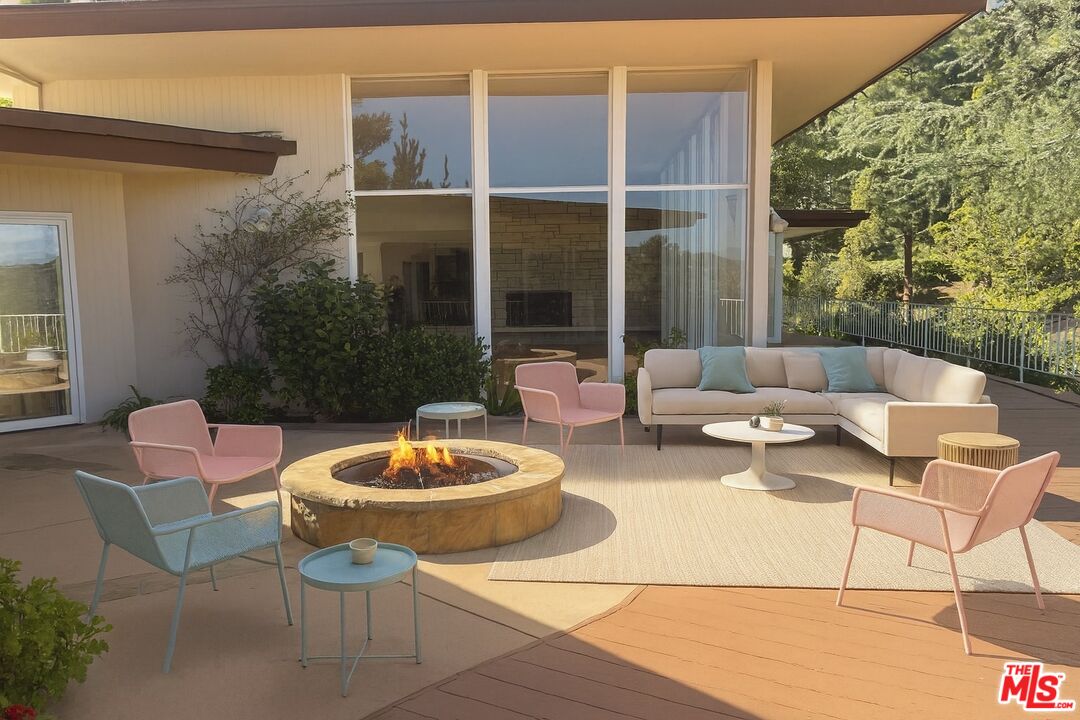 1743 Stone Canyon Road Los Angeles, CA 90077 - Photo 11 of 28 a patio with patio a fire pit and outdoor seating
