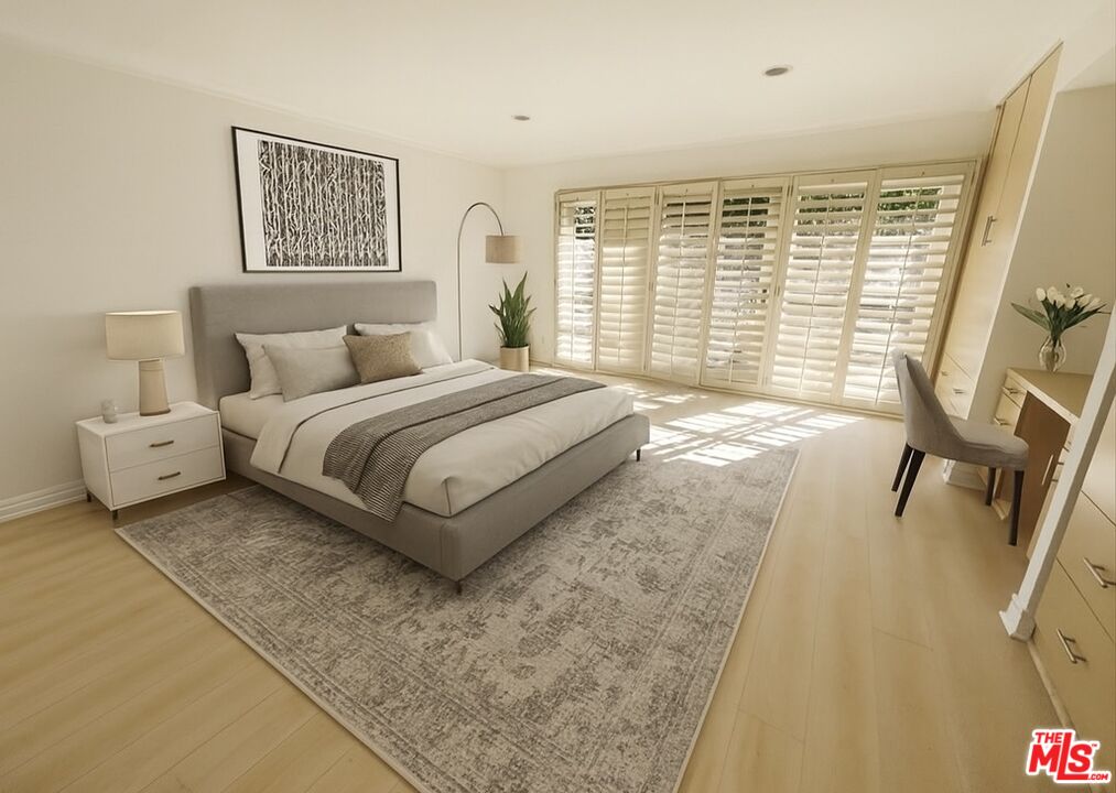 1743 Stone Canyon Road Los Angeles, CA 90077 - Photo 21 of 28 a bedroom with a bed and a large window