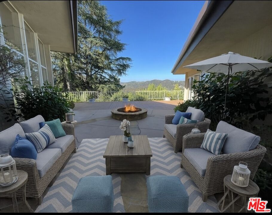 1743 Stone Canyon Road Los Angeles, CA 90077 - Photo 25 of 28 a view of a patio with couches and pool