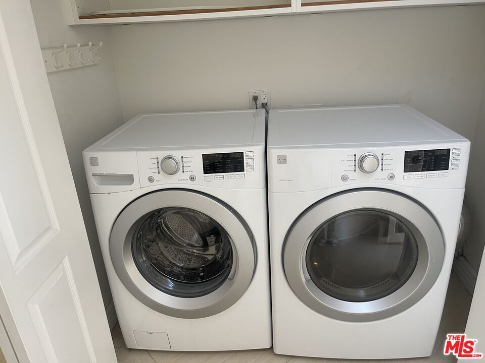 1743 Stone Canyon Road Los Angeles, CA 90077 - Photo 27 of 28 a utility room with dryer and washer