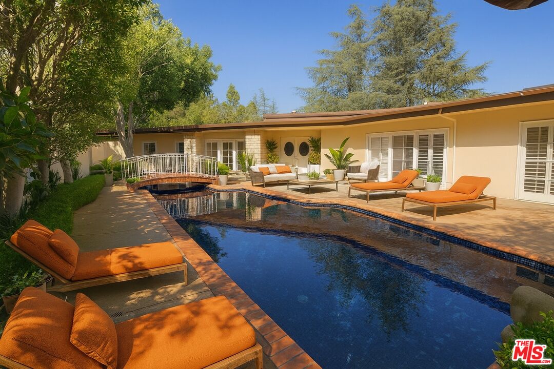 1743 Stone Canyon Road Los Angeles, CA 90077 - Photo 3 of 28 swimming pool view with a seating space