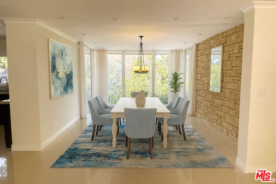 1743 Stone Canyon Road Los Angeles, CA 90077 - Photo 5 of 28 a view of a dining room with furniture window and wooden floor