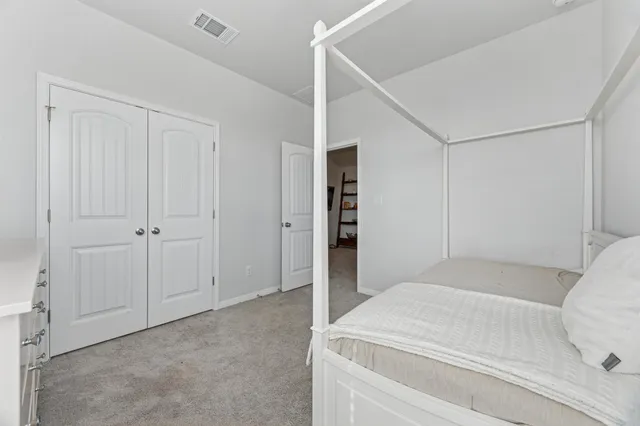 a bedroom with a bed and a cabinets