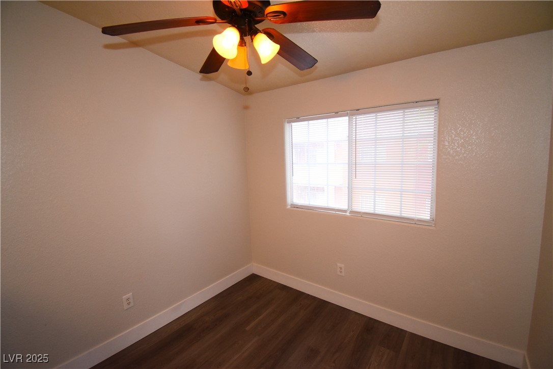 4730 East Craig Road, Unit 2094 Las Vegas, NV 89115 - Photo 7 of 12 Unfurnished room with dark wood-style floors and ceiling fan