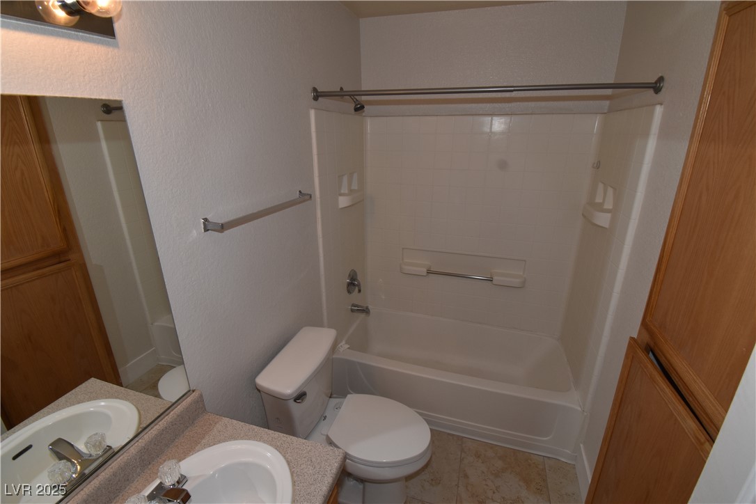 4730 East Craig Road, Unit 2094 Las Vegas, NV 89115 - Photo 10 of 12 Full bath with vanity, shower / tub combination, light tile patterned floors, and a textured wall