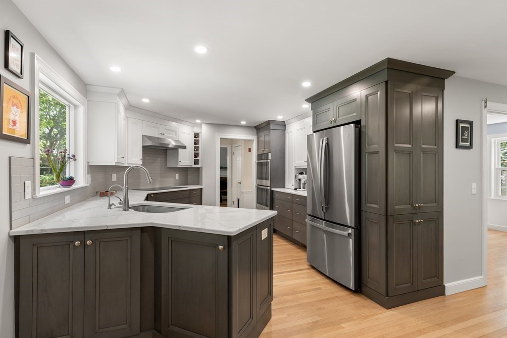 58 Old Coach Road Sudbury, MA 01776 - Photo 12 of 40 a kitchen with stainless steel appliances granite countertop a refrigerator and a sink