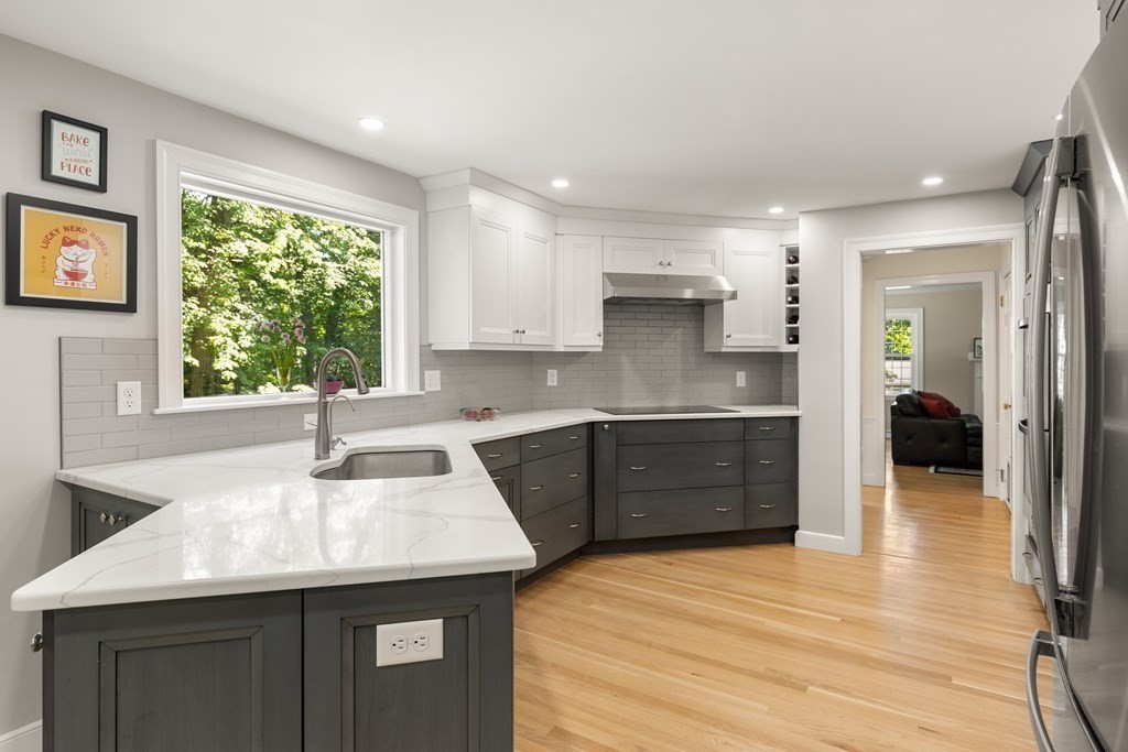 58 Old Coach Road Sudbury, MA 01776 - Photo 14 of 40 a kitchen with a sink stove and cabinets