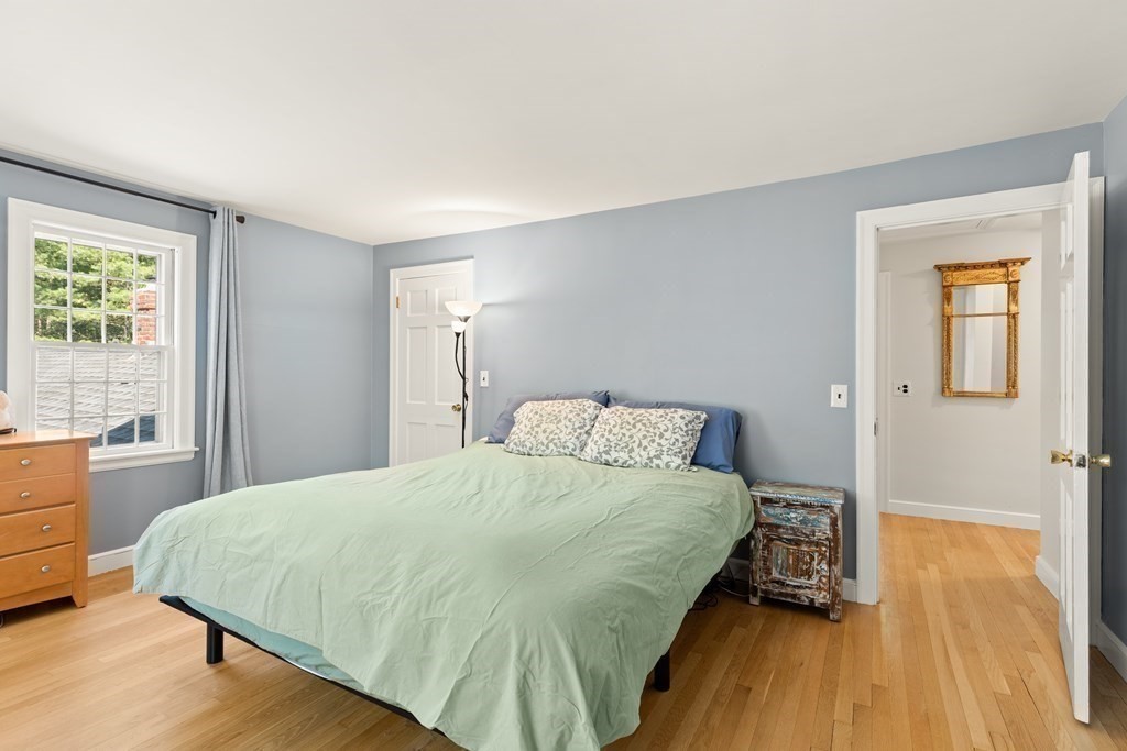 58 Old Coach Road Sudbury, MA 01776 - Photo 31 of 40 a bedroom with a bed and wooden floor