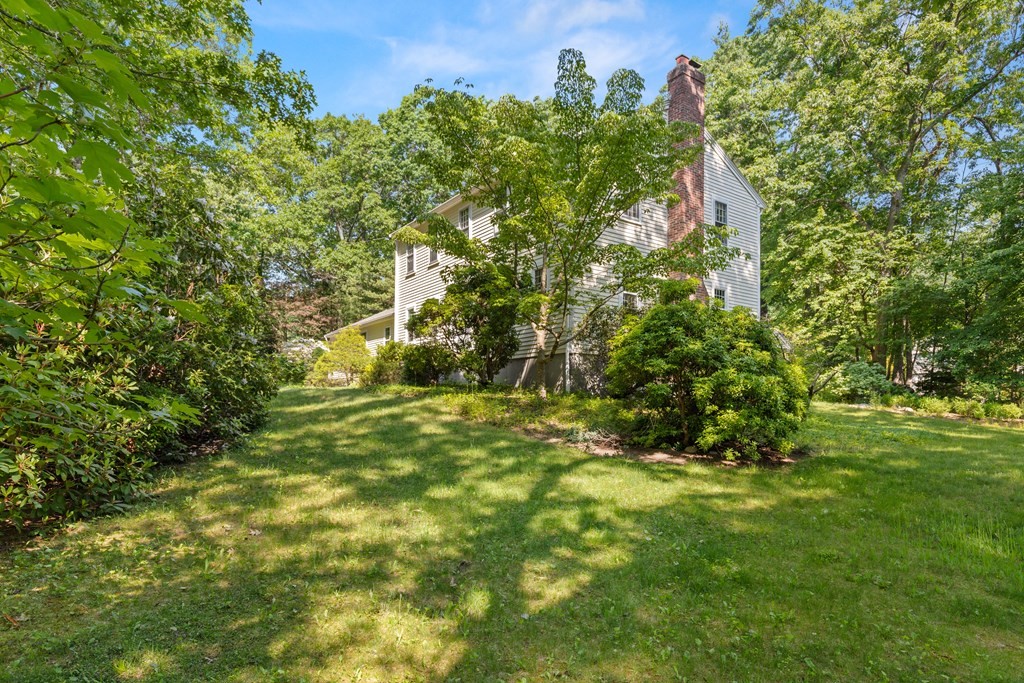 58 Old Coach Road Sudbury, MA 01776 - Photo 4 of 40 a view of a big yard with large trees