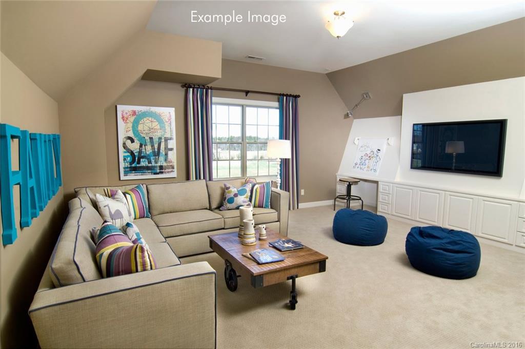 5271 Meadowcroft Way, Unit HAG0036 Fort Mill, SC 29708 - Photo 3 of 9 a living room with furniture a flat screen tv and a large window