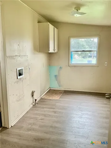 a view of a room with wooden floor and cabinet