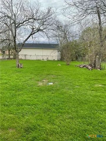 a view of an house with backyard space and garden