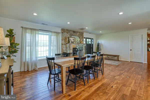 a view of a house with a big yard and a large trees