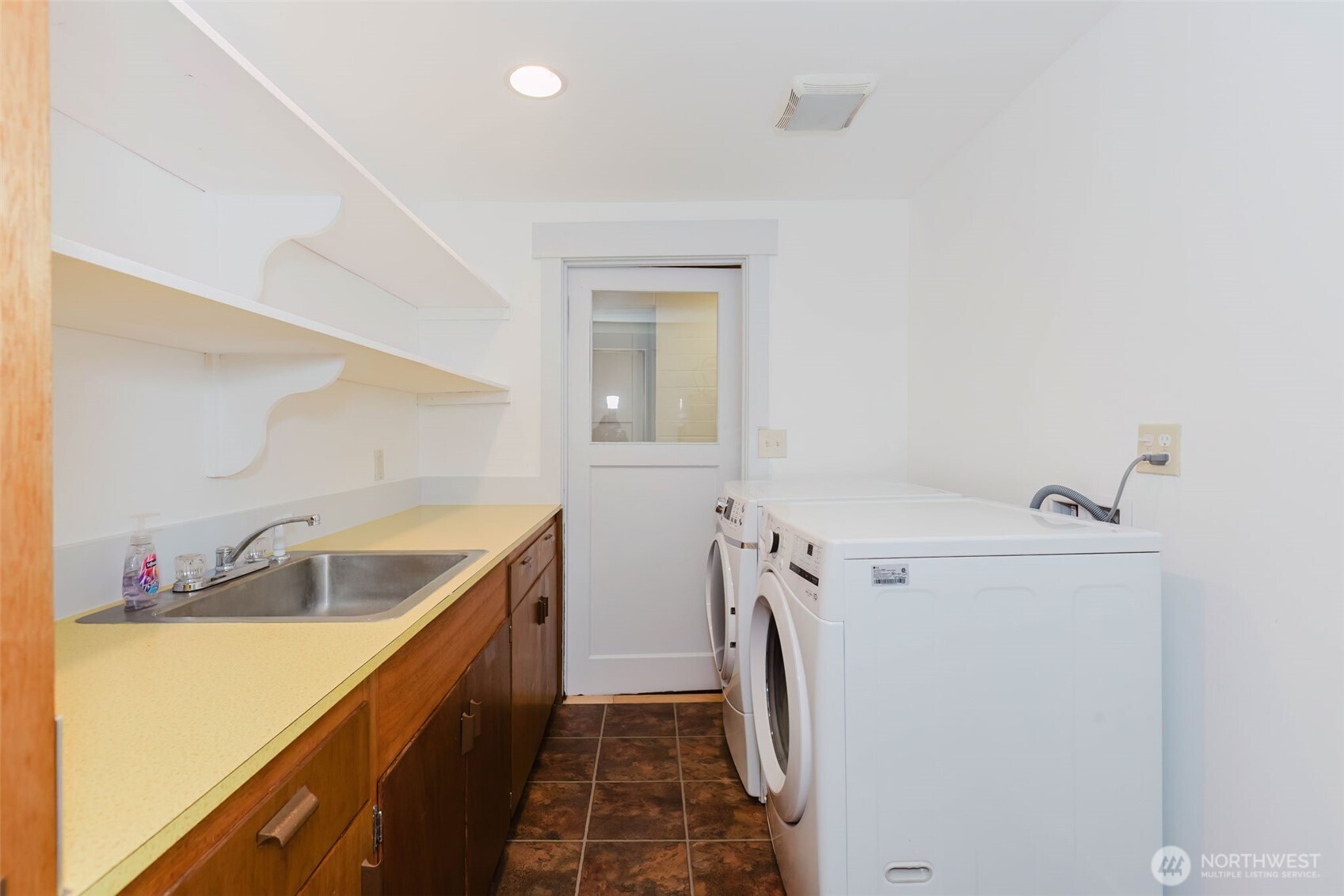 12241 Olalla Valley Road Southeast Olalla, WA 98359 - Photo 22 of 39 a bathroom with a sink and mirror with bathtub