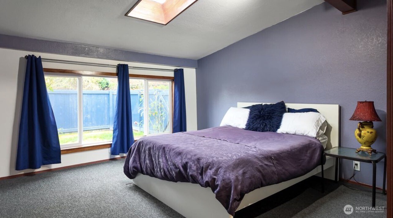11090 25th Avenue Southwest Seattle, WA 98146 - Photo 15 of 38 a bedroom with a bed and a window