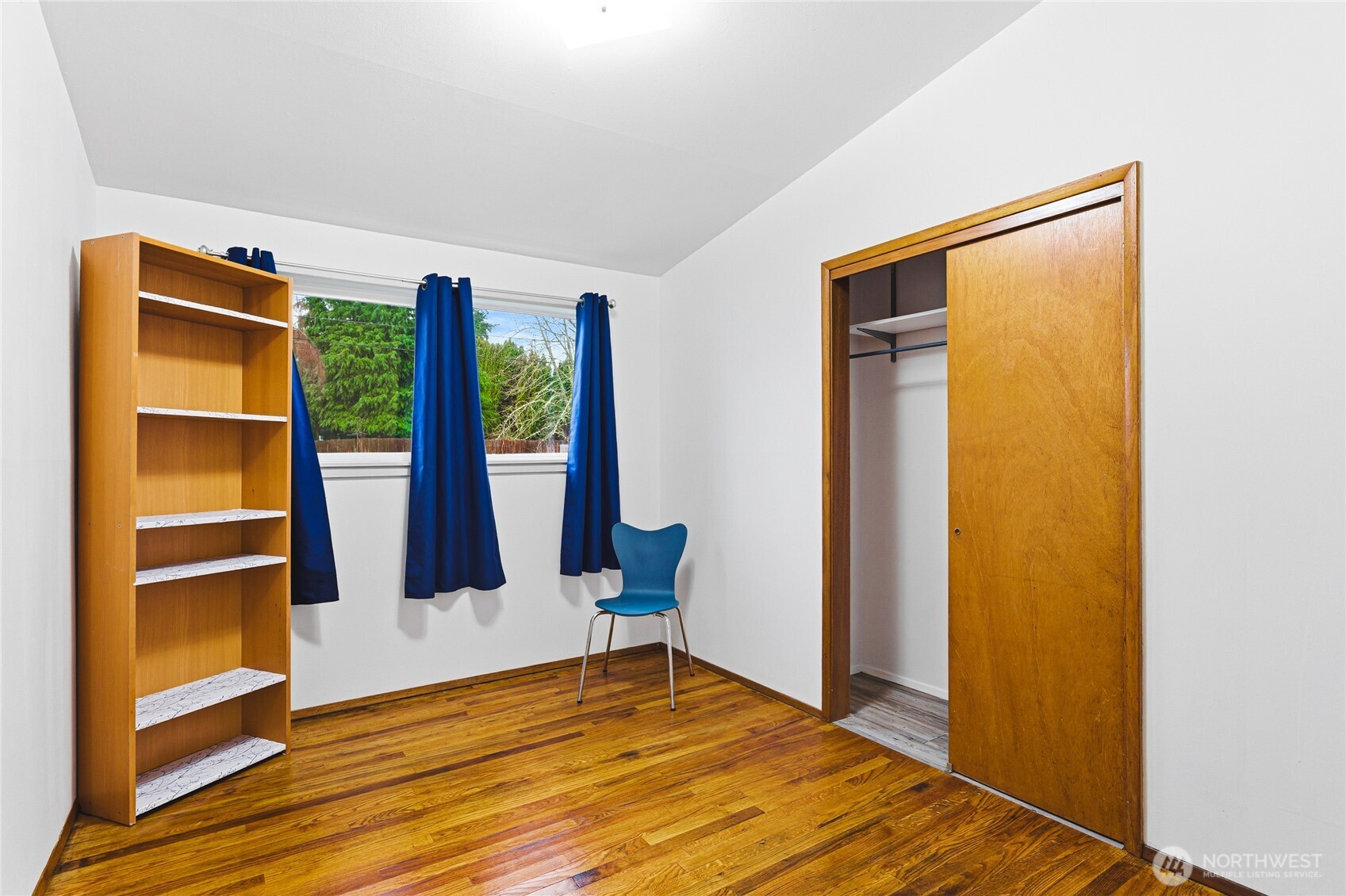11090 25th Avenue Southwest Seattle, WA 98146 - Photo 19 of 38 a view of an empty room with wooden floor and windows