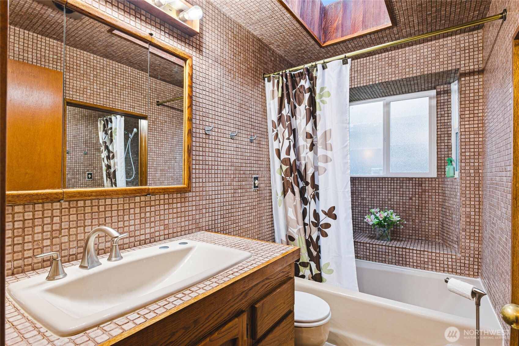 11090 25th Avenue Southwest Seattle, WA 98146 - Photo 26 of 38 a bathroom with a sink and a bathtub