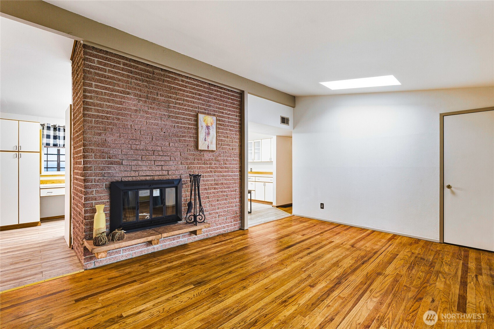 11090 25th Avenue Southwest Seattle, WA 98146 - Photo 5 of 38 a view of empty room with wooden floor and fireplace