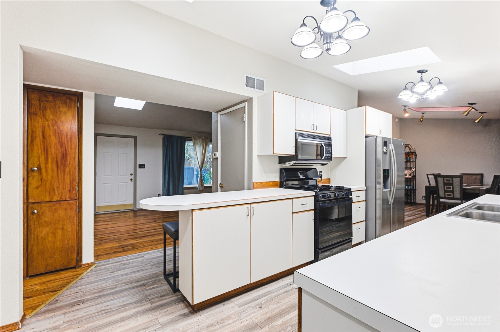 11090 25th Avenue Southwest Seattle, WA 98146 - Photo 7 of 38 a kitchen that has a lot of cabinets and refrigerator
