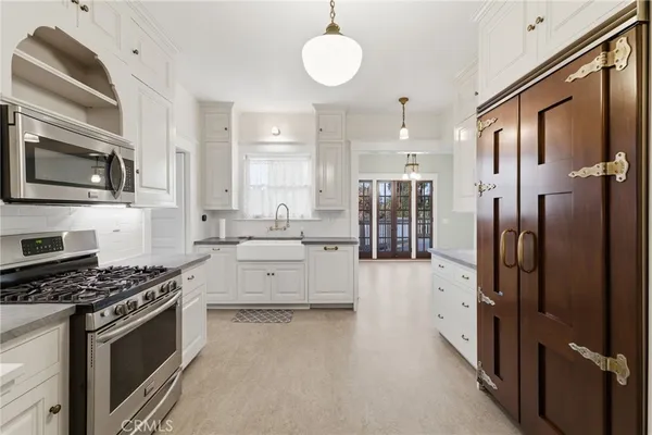 a kitchen with stainless steel appliances granite countertop a stove a sink and a refrigerator