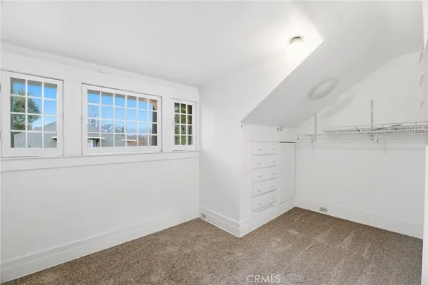 an empty room with fan and windows
