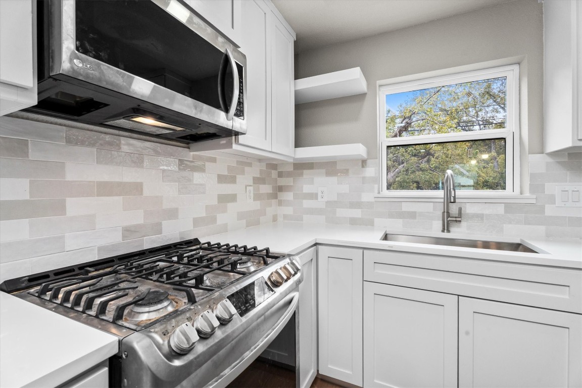 6162 Beldart Street Houston, TX 77033 - Photo 11 of 36 a kitchen with a stove and a sink
