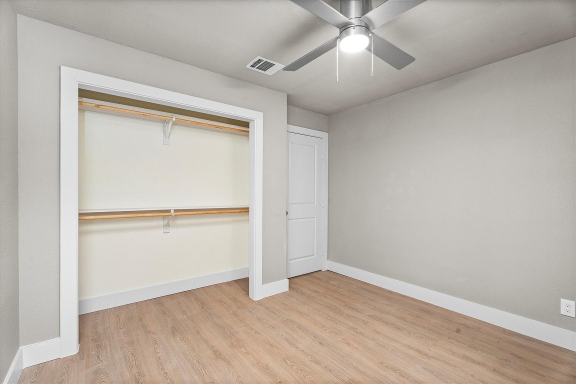 6162 Beldart Street Houston, TX 77033 - Photo 25 of 36 an empty room with wooden floor closet and windows