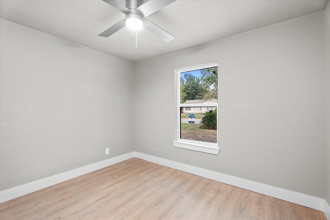 6162 Beldart Street Houston, TX 77033 - Photo 27 of 36 an empty room with a window and a fan