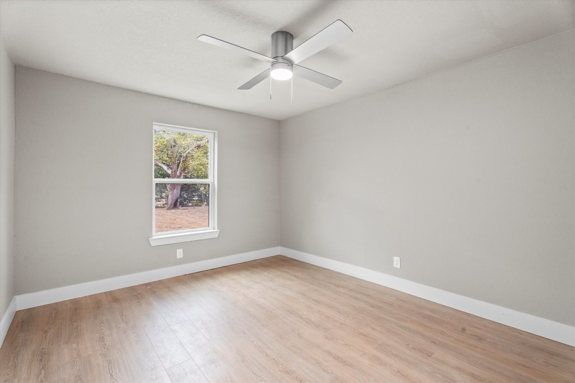 6162 Beldart Street Houston, TX 77033 - Photo 31 of 36 an empty room with wooden floor and windows