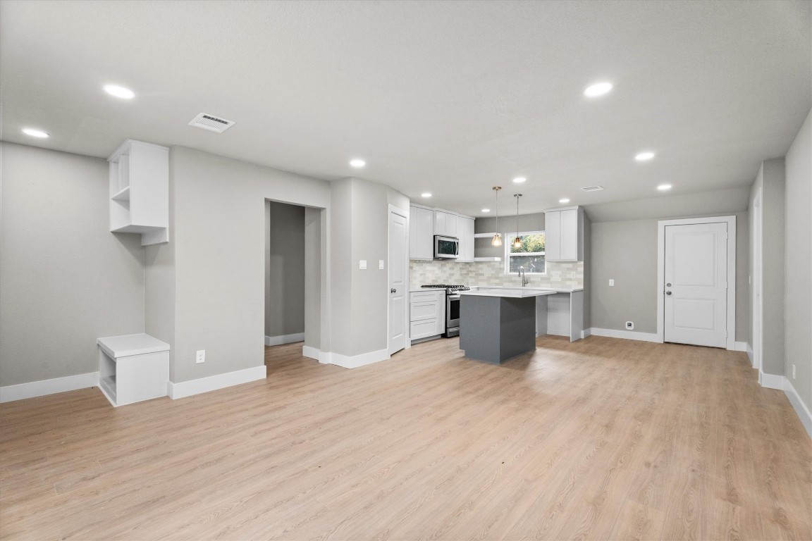 6162 Beldart Street Houston, TX 77033 - Photo 8 of 36 a view of a kitchen with a sink and wooden floor