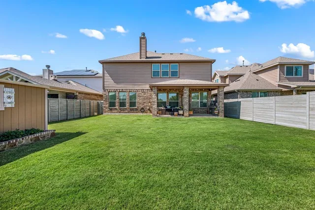 a view of a house with a back yard