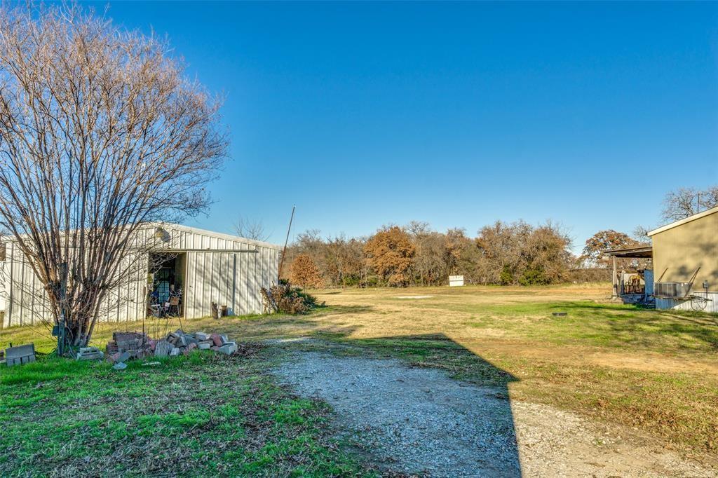 319 County Road 4868 Azle, TX 76020 - Photo 5 of 22 View of the front of the Barn with the grazing pasture behind. The mobile home to the right is no longer on the property.