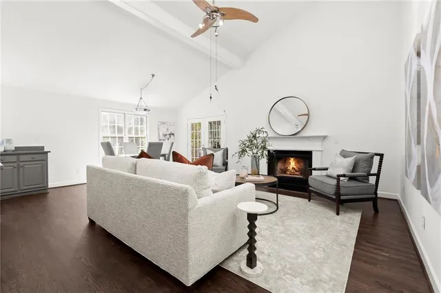 a living room with furniture a fireplace and a chandelier