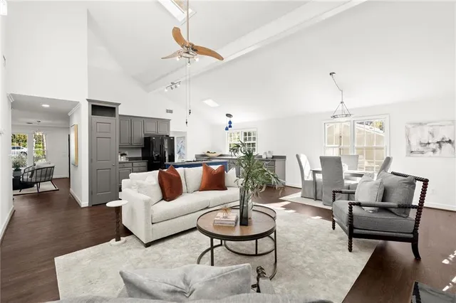 a living room with furniture and a chandelier