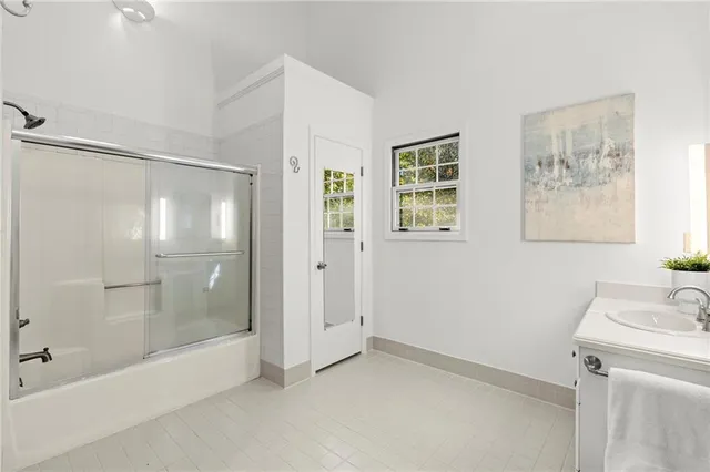 a bathroom with a shower and a sink