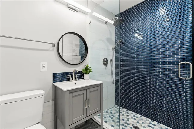 a bathroom with a sink toilet and shower