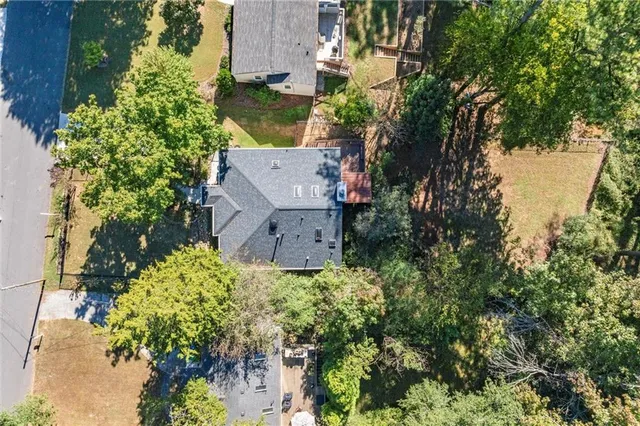 an aerial view of a house with a yard