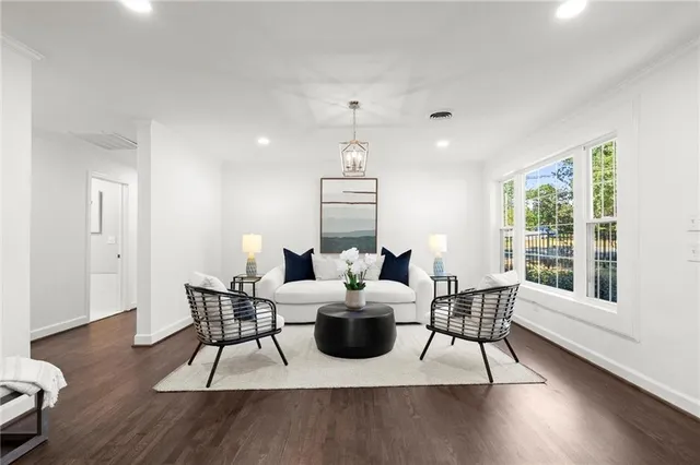 a living room with furniture a wooden floor and a window
