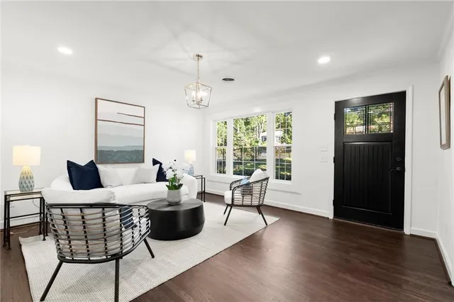 a living room with furniture and wooden floor