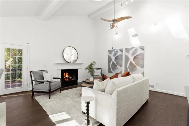 a living room with furniture a fireplace and a window